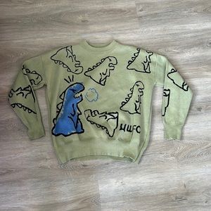 A green dinosaur sweater